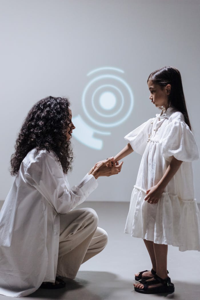 gallery-5 A mother and daughter engage with a digital interface projection in a studio setting.